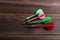 Four colored darts on a wooden background. Hit the target