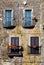 Four colored windows with balcony. Old italian vintage style.