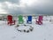 Four Colorful Chairs on a Winter Beach