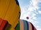 Four Colorful Hot Air Balloons with Two in Flight in Cloudy Skies