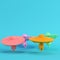 Four colorful ufos or alien spaceships on bright blue background in pastel colors