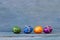 Four colourful Easter eggs on a blue wooden background