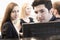 Four coworkers sitting and discussing in the office by the computer monitors