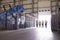 Four coworkers walking in an industrial interior, wide view