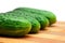 Four cucumbers with pimples on kitchen board