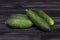 Four cucumbers on wood.