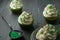 Four cupcakes in green paper
