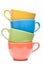 Four cups stacked. Colored mugs. Colorful image with tableware.