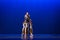 Four dancers pose against dark blue background on stage