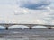 Four-deck passenger ship passes under the road bridge. Russia, city Saratov