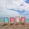 Four Deckchairs On A Pebble Beach