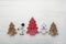 Four decorative wooden Christmas trees with carved letters xmas.