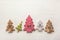 Four decorative wooden Christmas trees with carved letters xmas.