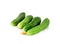Four delicious little prickly green cucumbers light bite on a white isolated
