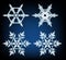 Four designs of snowflakes on blue background