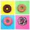 Four different donuts on bright multicolored background top view