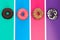 Four different donuts on bright multicolored background top view