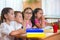 Four diligent pupils studying at classroom