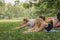 Four diverse woman friends having fun workout and yoga together in park