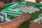 Four elderly women playing and gambling in mahjong at the countryside of southern China. Focus on