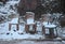 Four Empty Chairs and Ground Covered by Snow - Active Snow Fall - Snow Flakes in Air - Abstract Winter Eerie Still Life