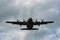 Four engined cargo aircraft flying overhead