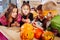 Four excited beaming children with painted faces wearing Halloween costumes