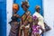 Four female celebrants of Emancipation Day pose against a wall on Picadilly Street, Port-of-Spain, Trinidad on Emancipation Day