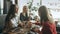 Four female friends enjoying in talking at cafe