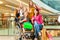 Four female friends shopping in a mall with wheelchair