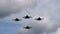 Four fighter planes flying overhead