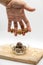 Four fingers holding mini homemade peanut butter energy balls ag