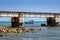 Four fishermen in their small boat catching fish under Pamban railway bridge