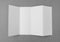 Four - fold white template paper on gray background .