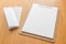 Four fold white template paper with wooden clipboard on wood background