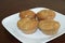 Four Fresh Muffins on White Plate and Cherry Table