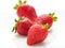 Four Fresh natural strawberries on a white background. Shallow d