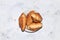 Four fresh ruddy croissants on a gray table with crumbs., Top view, place for text. Concept of a modern bakery. Delicious