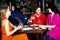 Four friends enjoying dinner at a restaurant