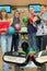 Four friends stand near tenpin bowling with balls