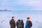 Four friends walk along the beach and look at the sea. Bird. Water. Travelling