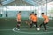 four futsal players practice with the ball