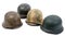 Four German World War Two Stahlhelm military helmets on white background