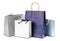 Four gift colored paper bags on white background. Close up