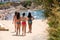 Four girls in bathing suits go to the beach in Sitges, Barcelona, Catalunya, Spain.