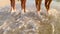 Four girls walking on the beach together in slow motion, happy girls on vacation at the beach