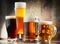 Four glassed of beer on wooden background