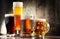 Four glassed of beer on wooden background
