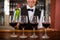 Four glasses of red wine ready to serve on bar counter