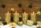 Four golden burning christmas candles for advent decoration.